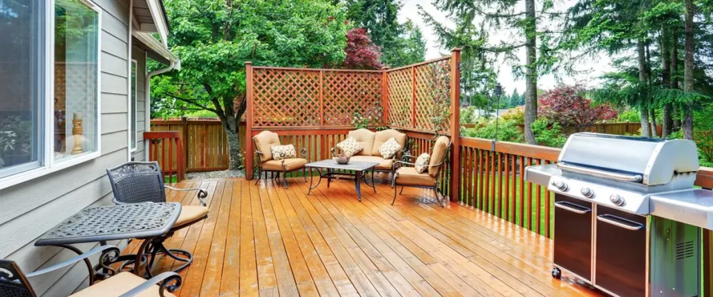Spacious wood deck with outdoor seating, privacy lattice and built-in grilling area.