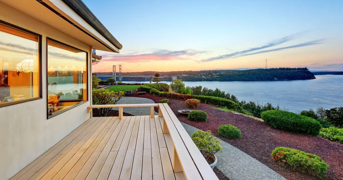 Waterfront wood deck with scenic sunset views of the bay and suspension bridge.