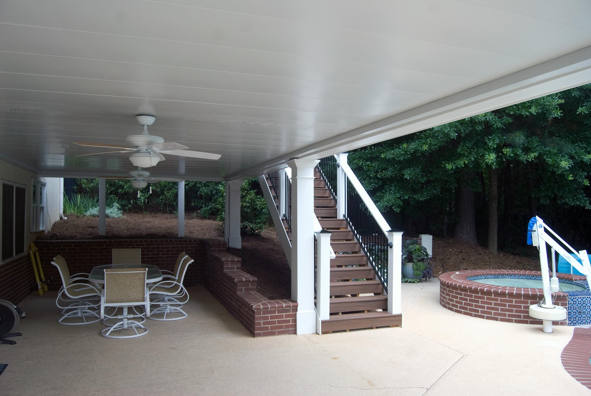 Aluminum under decking ceiling keeping the space below a deck dry beside a hot tub
