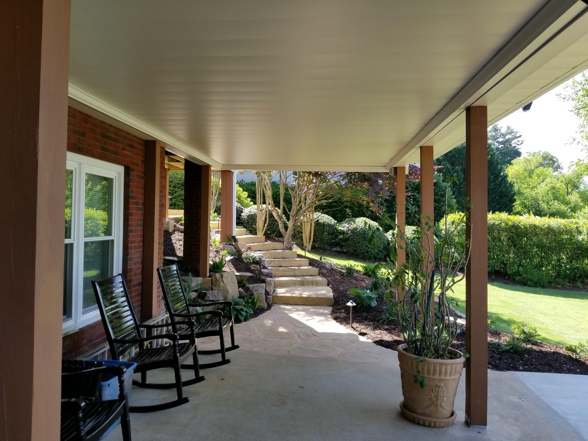 White aluminum under decking ceiling above a patio with rocking chairs