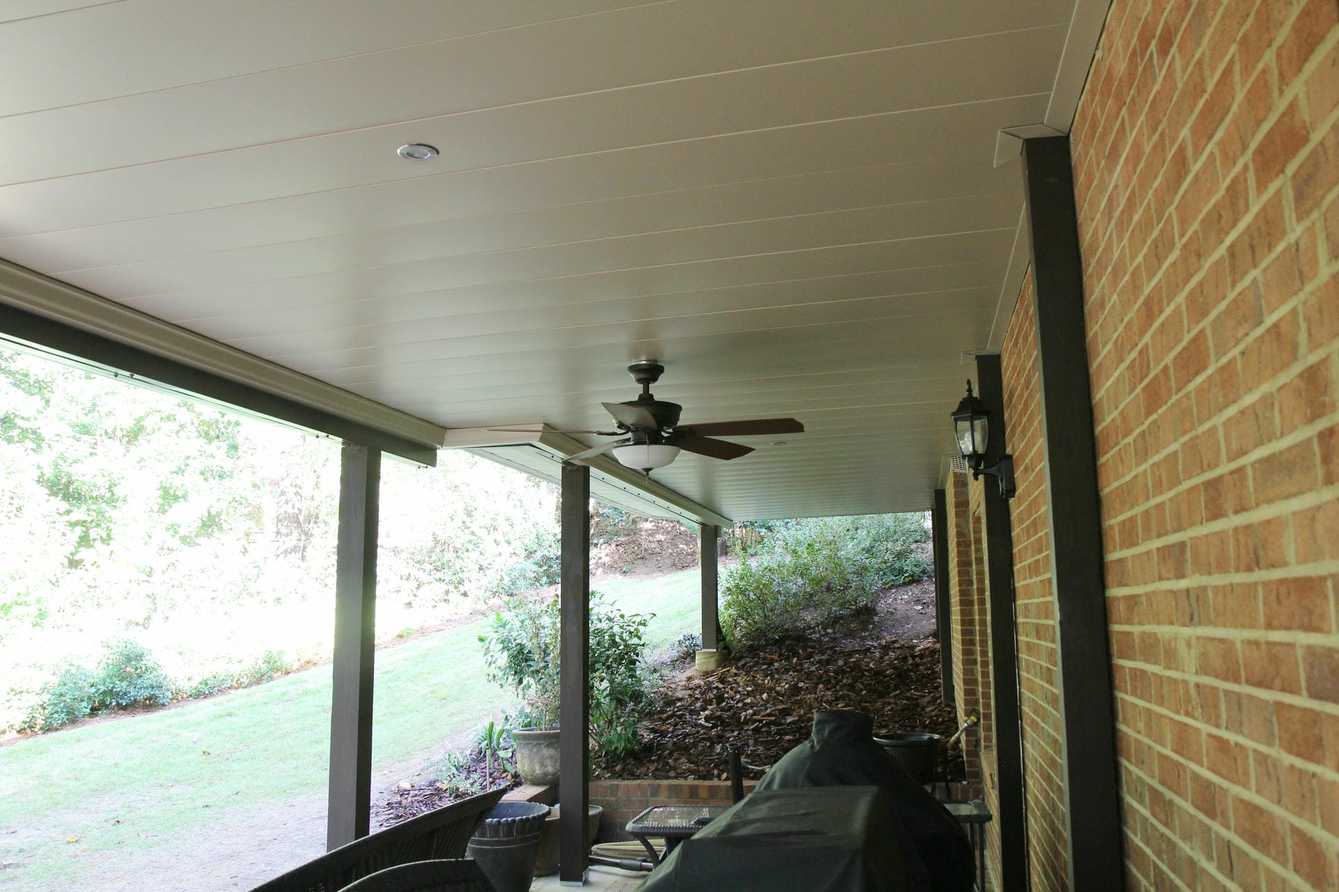 Aluminum under decking panels and a ceiling fan above a brick patio in Dunwoody
