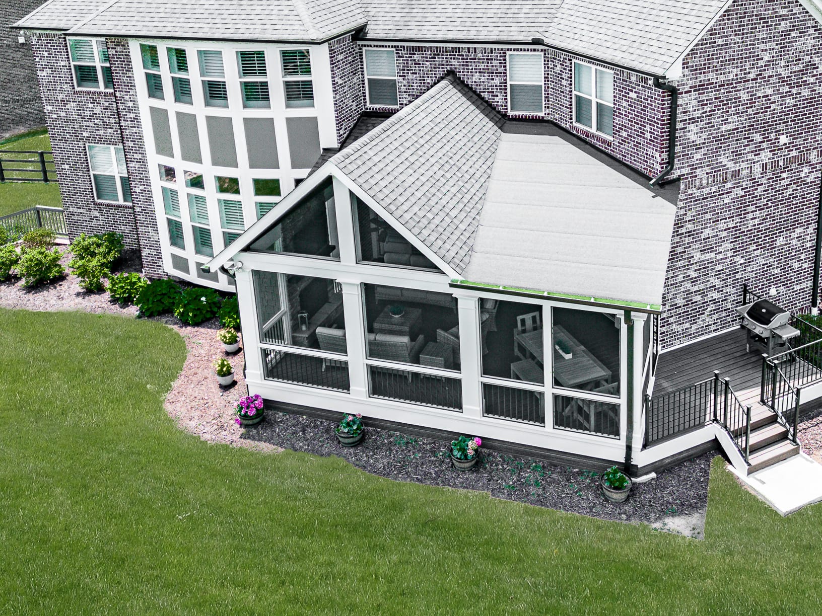 Aerial view of a combination porch roof with a gable end and a lower shed slope