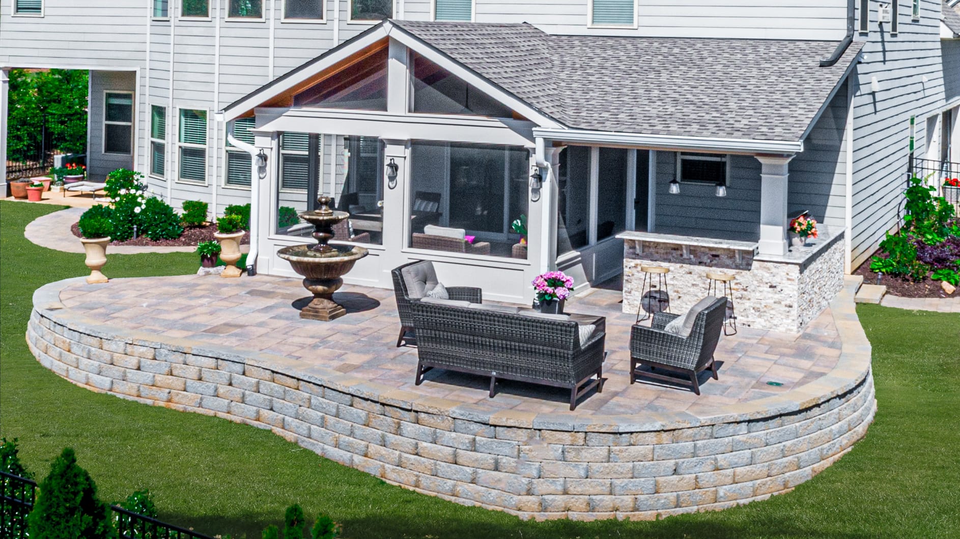 Combination porch roof above a screened porch and paver patio