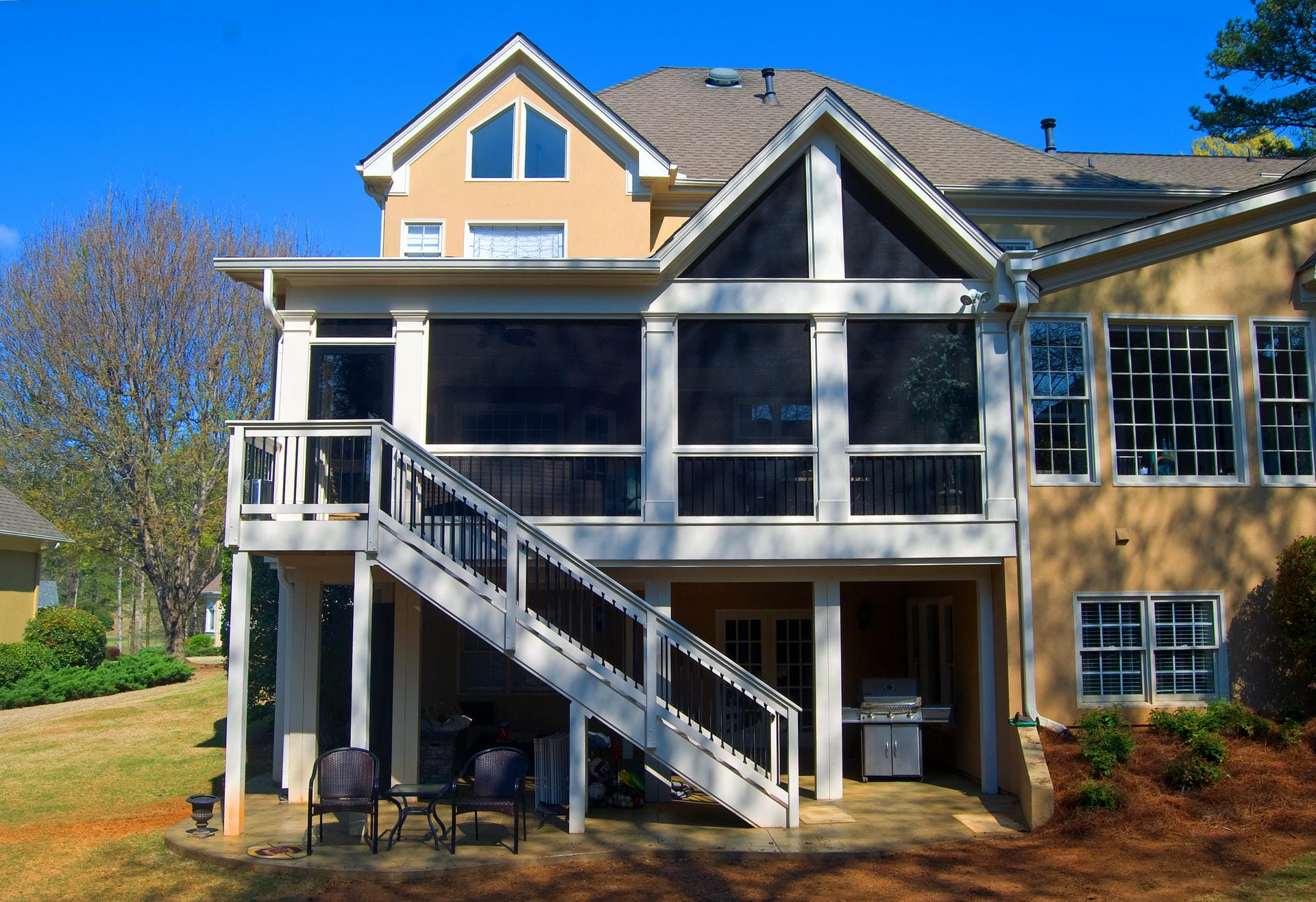 Two story screened porch with a gable end and a shed roof over the sunroom