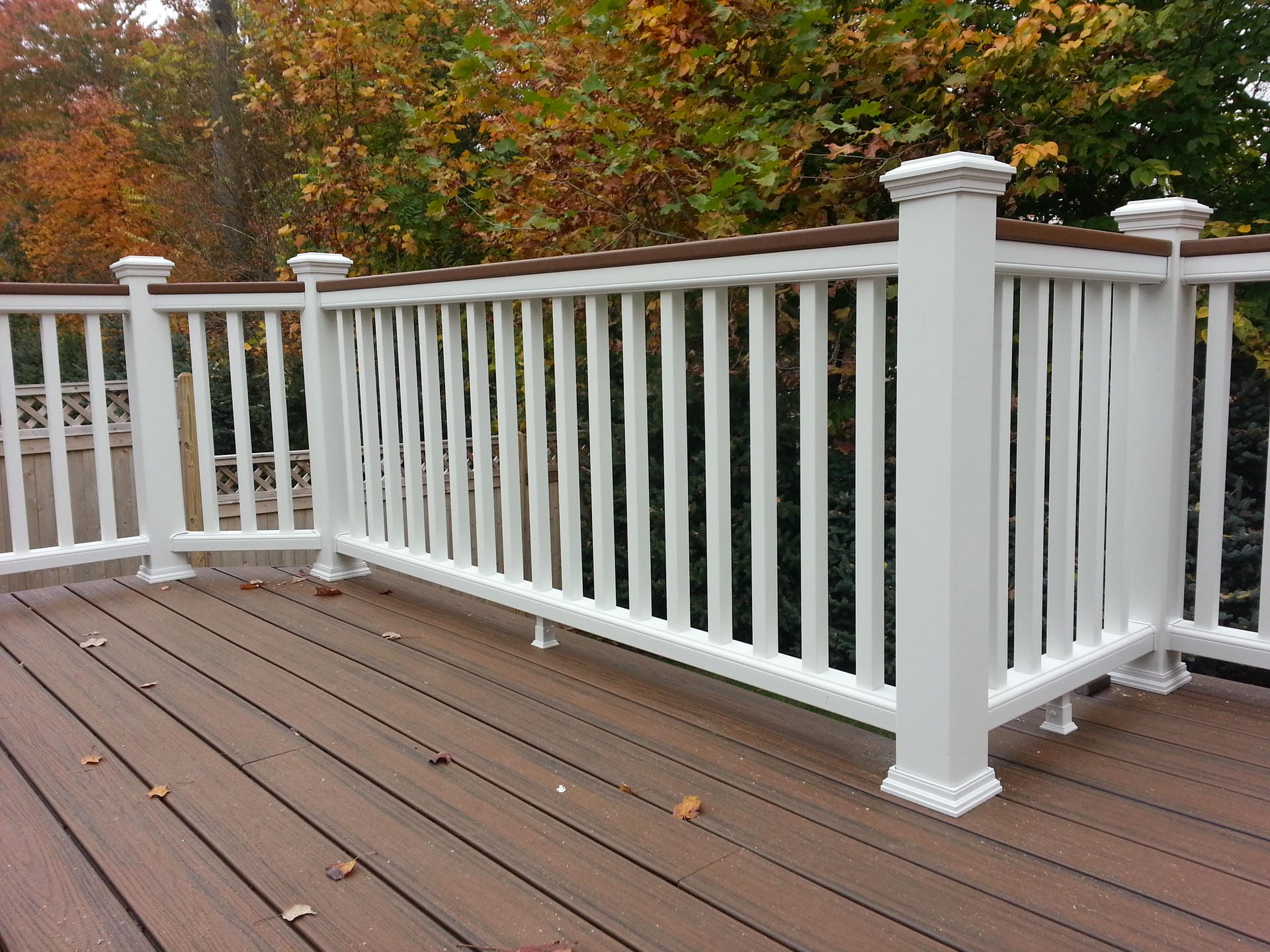 All white composite deck railing with square posts and post caps