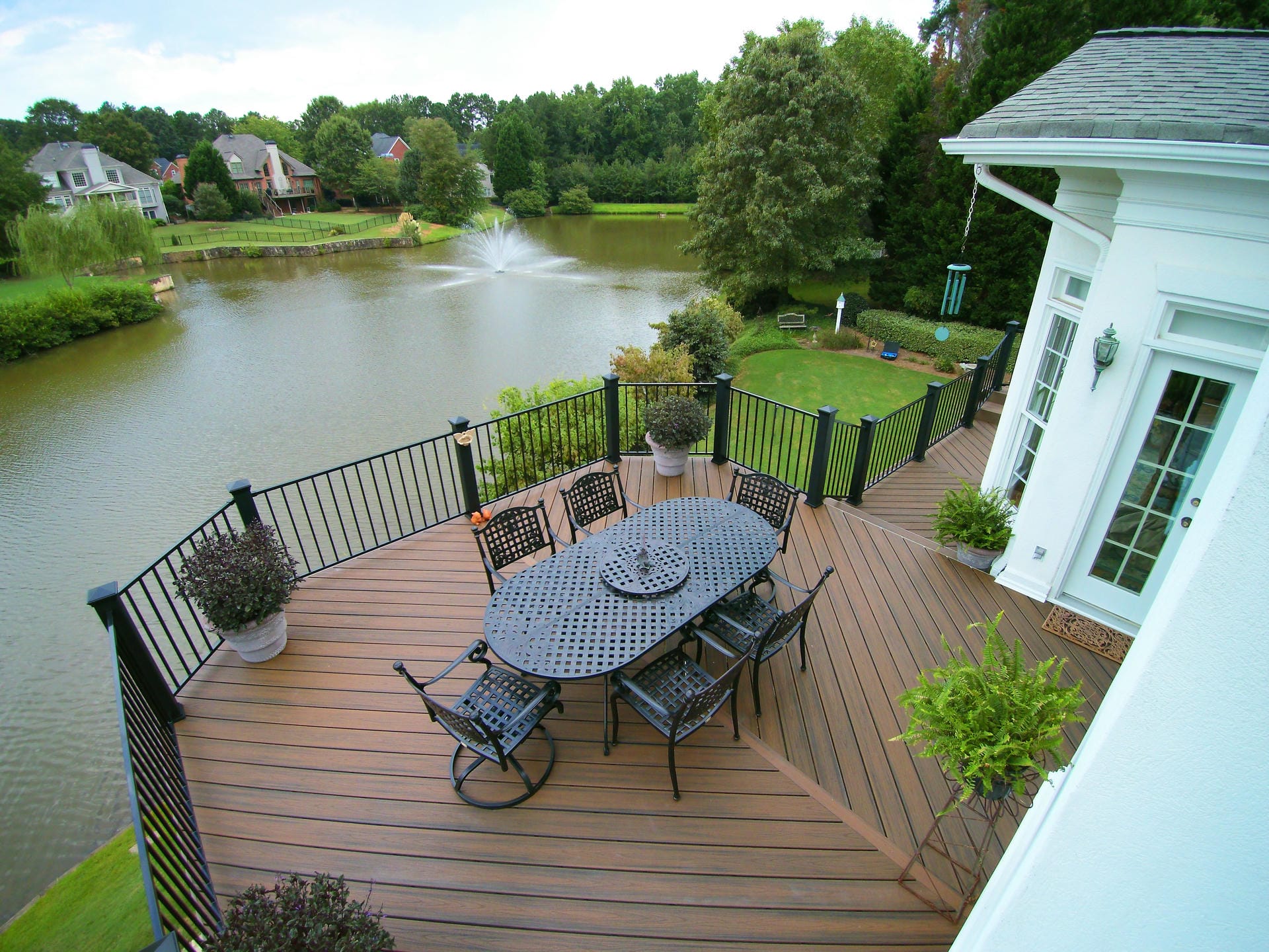 Warm brown composite deck with black railing overlooking a pond in North Atlanta