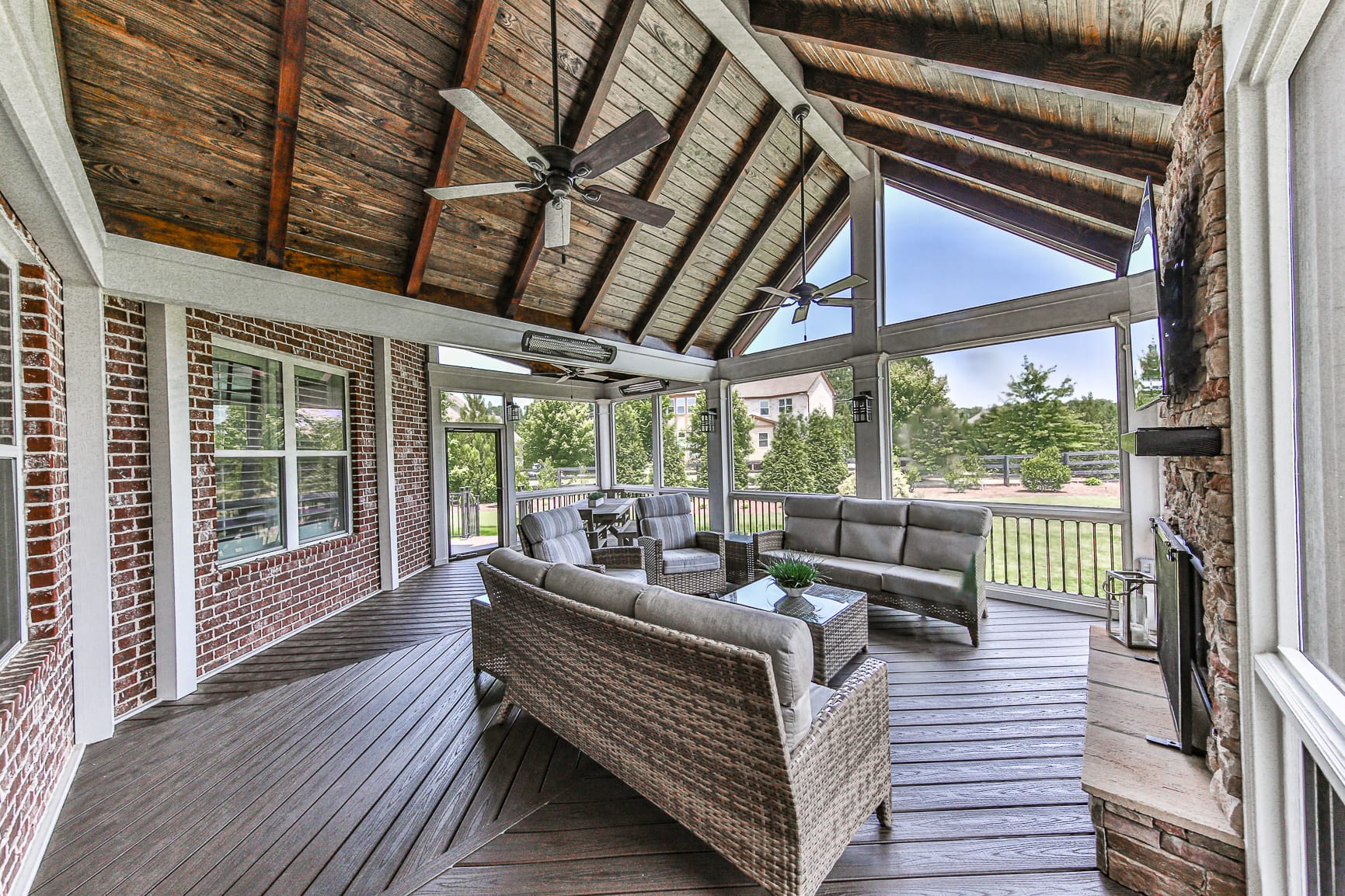 Screened porch with exposed cedar rafters open to the backyard