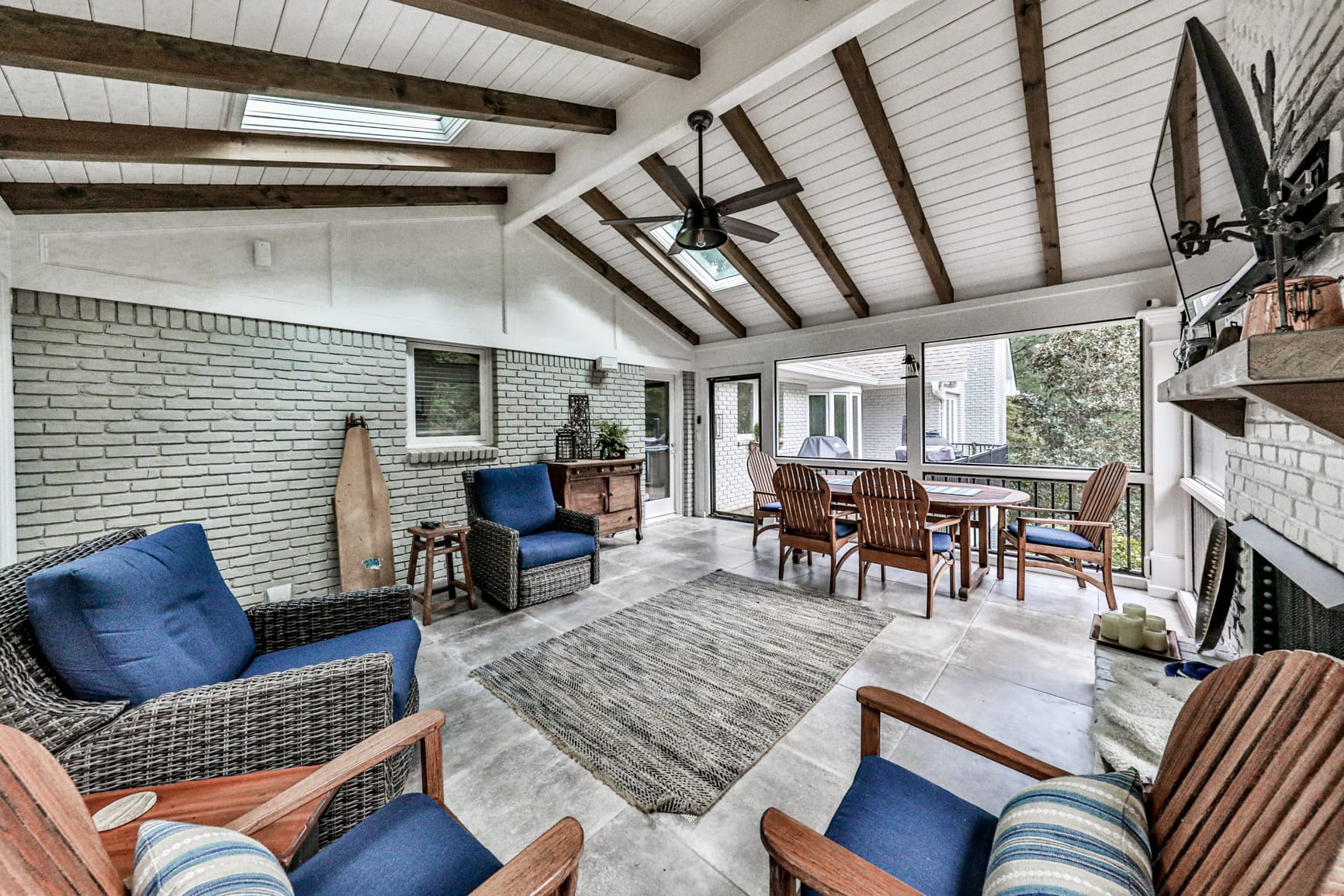 Screened porch with cedar rafters and a wooded backyard view