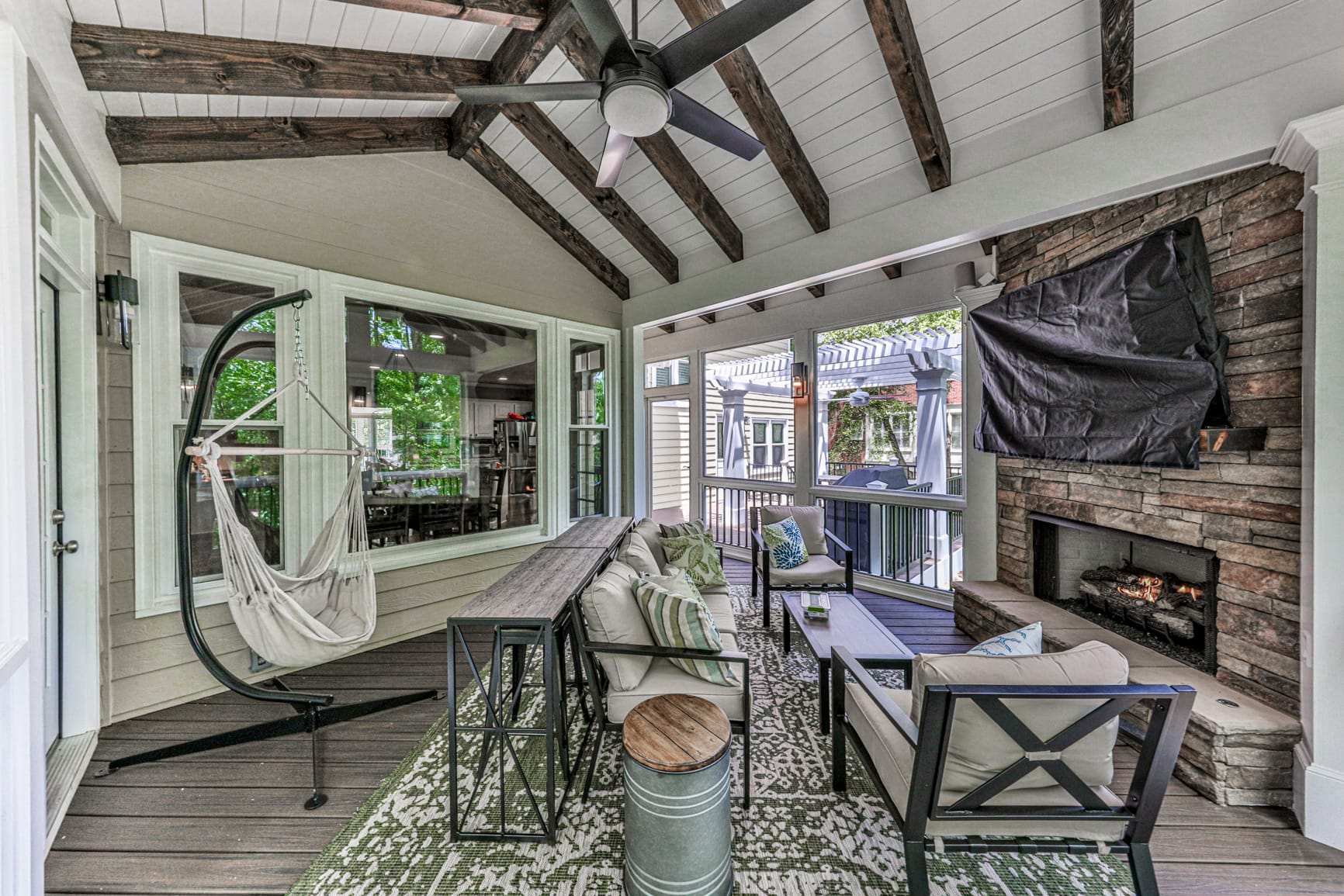 Screened porch ceiling detail showing cedar rafters and ceiling fan