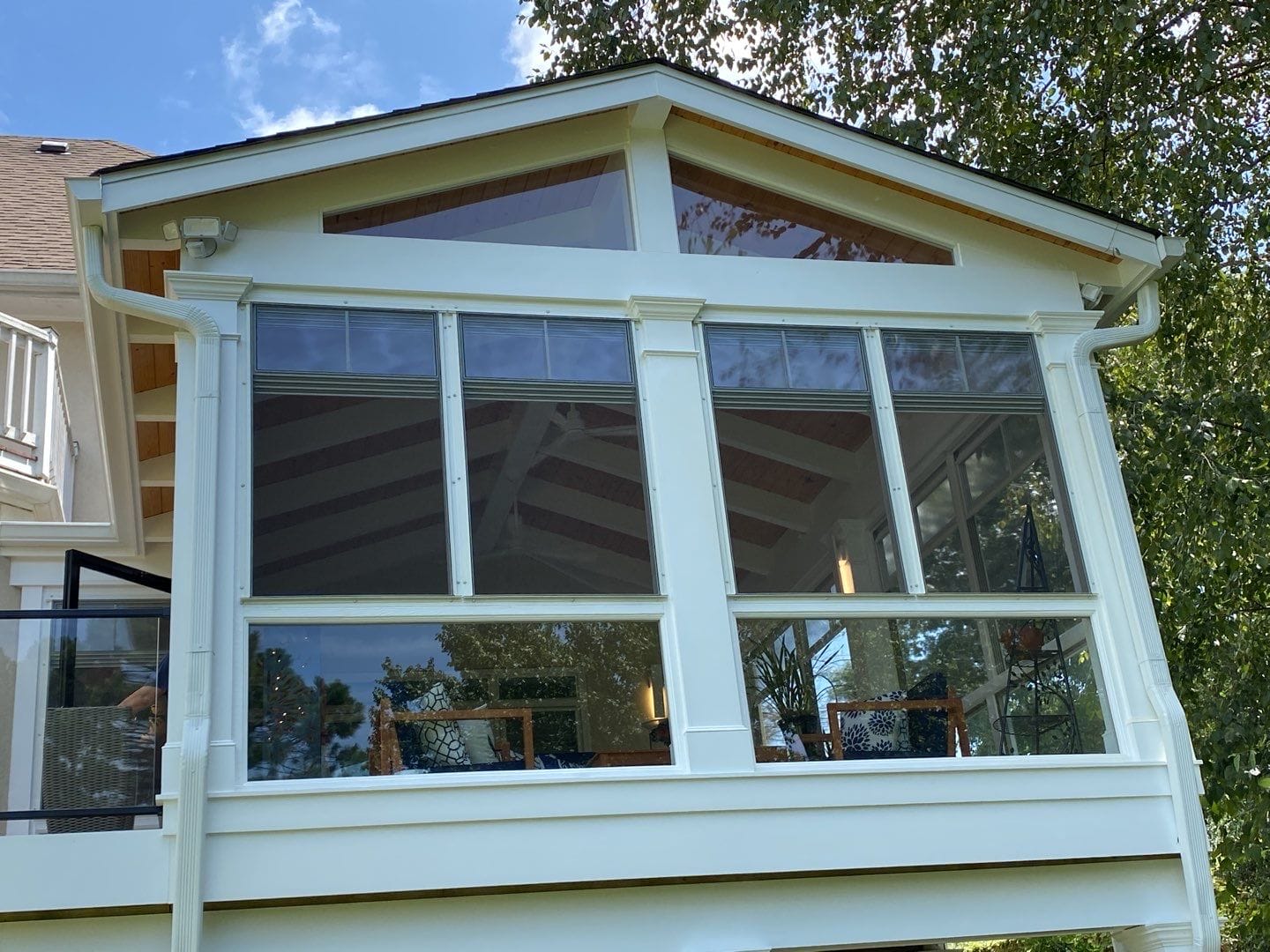 Exterior view of a porch enclosed with EZE-Breeze windows and tempered glass