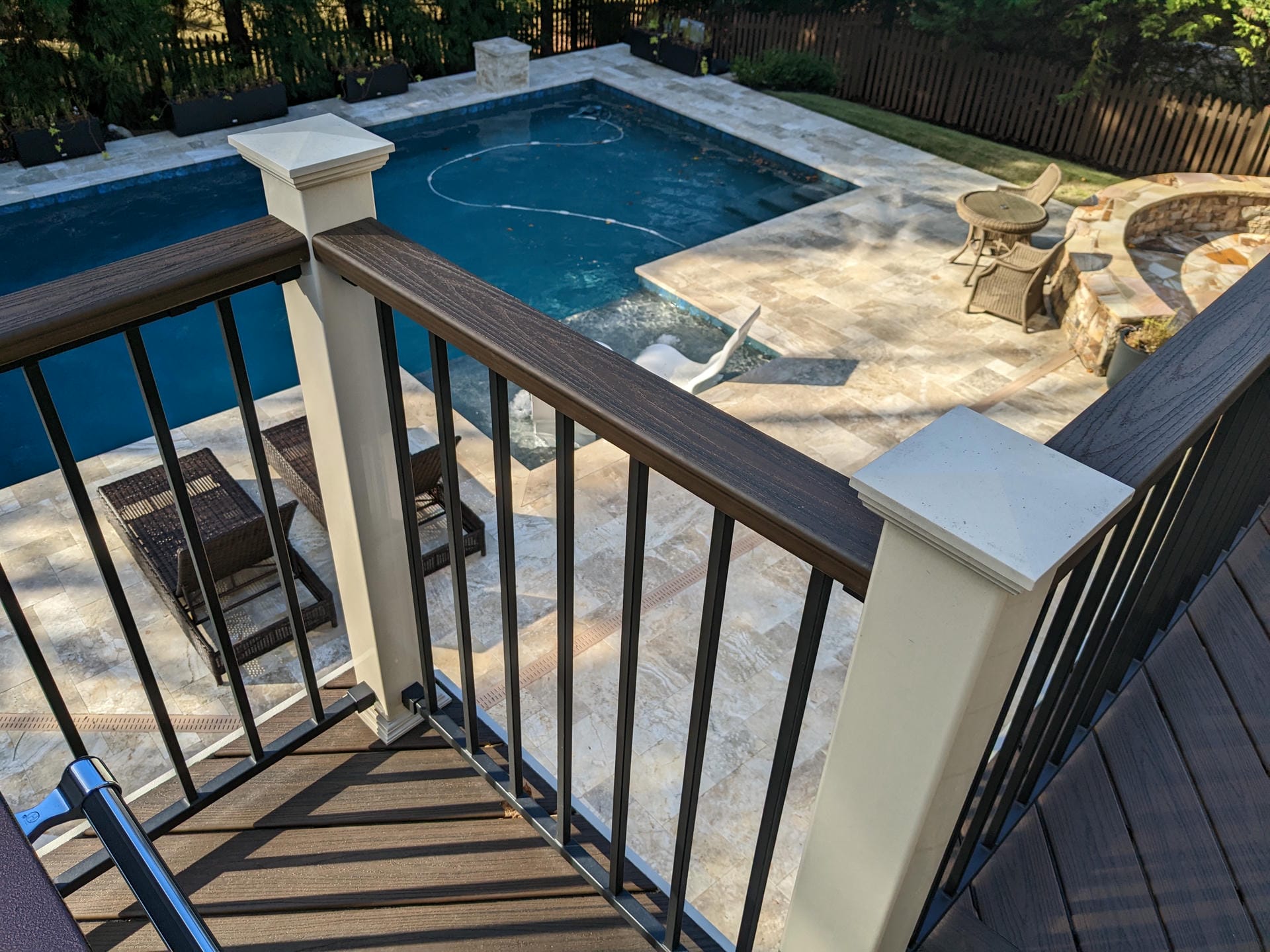 Fortress Fe26 railing with white posts on a deck overlooking a pool