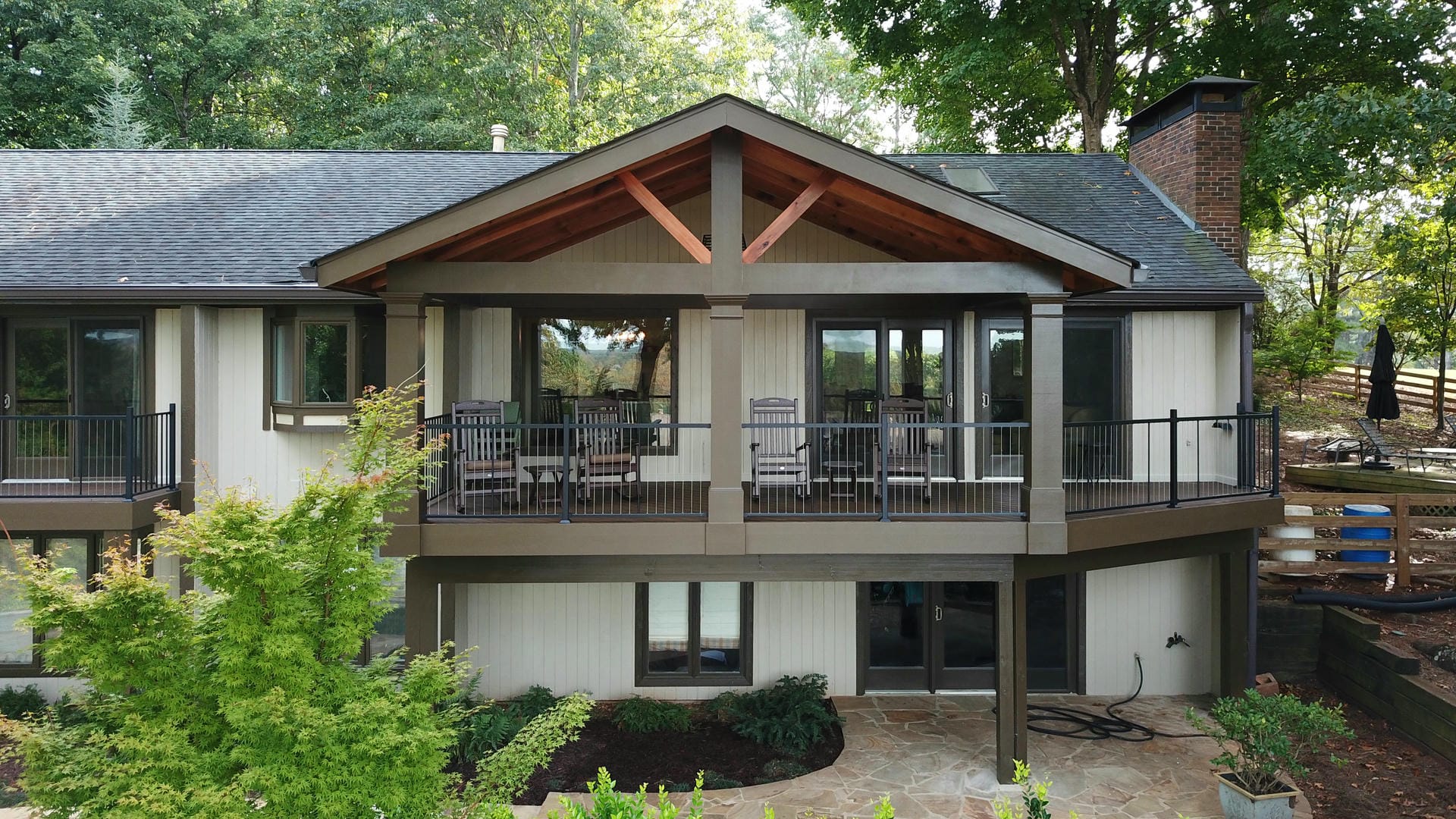 Elevated screened porch with a cedar truss framed into the gable peak