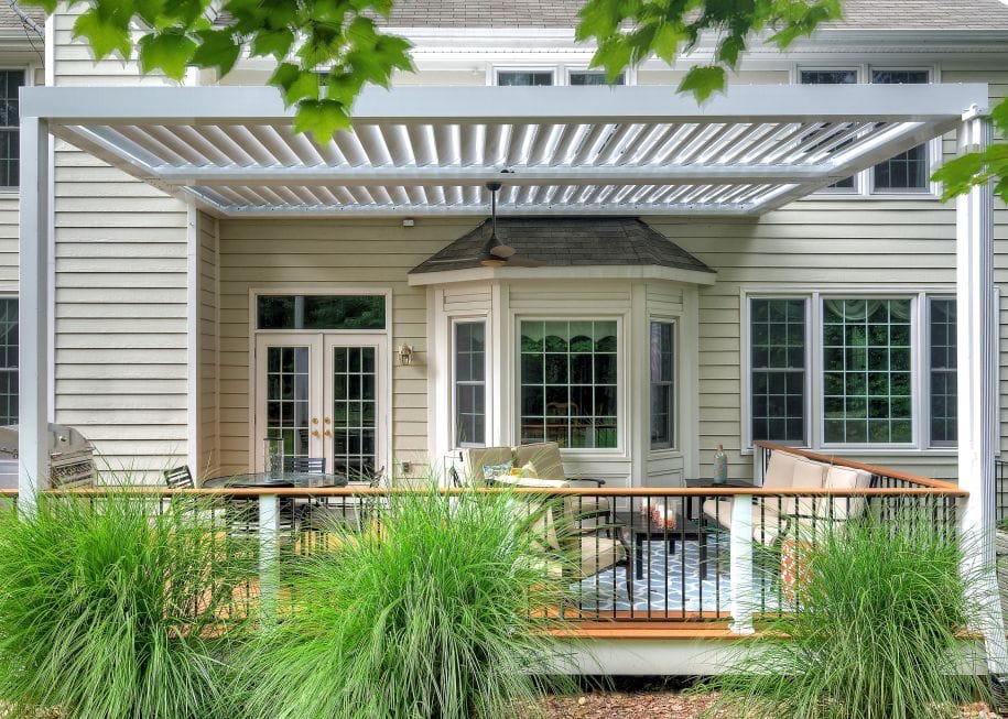 White louvered roof matched to the trim of a traditional cream sided home