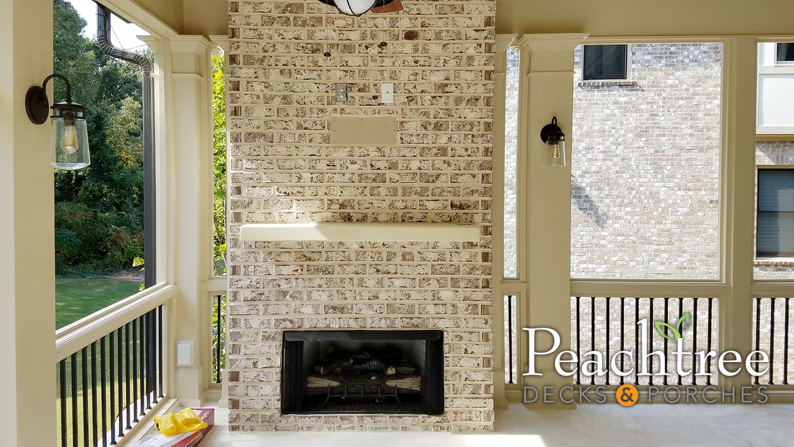 Vent-free gas fireplace with thin brick surround on a covered porch
