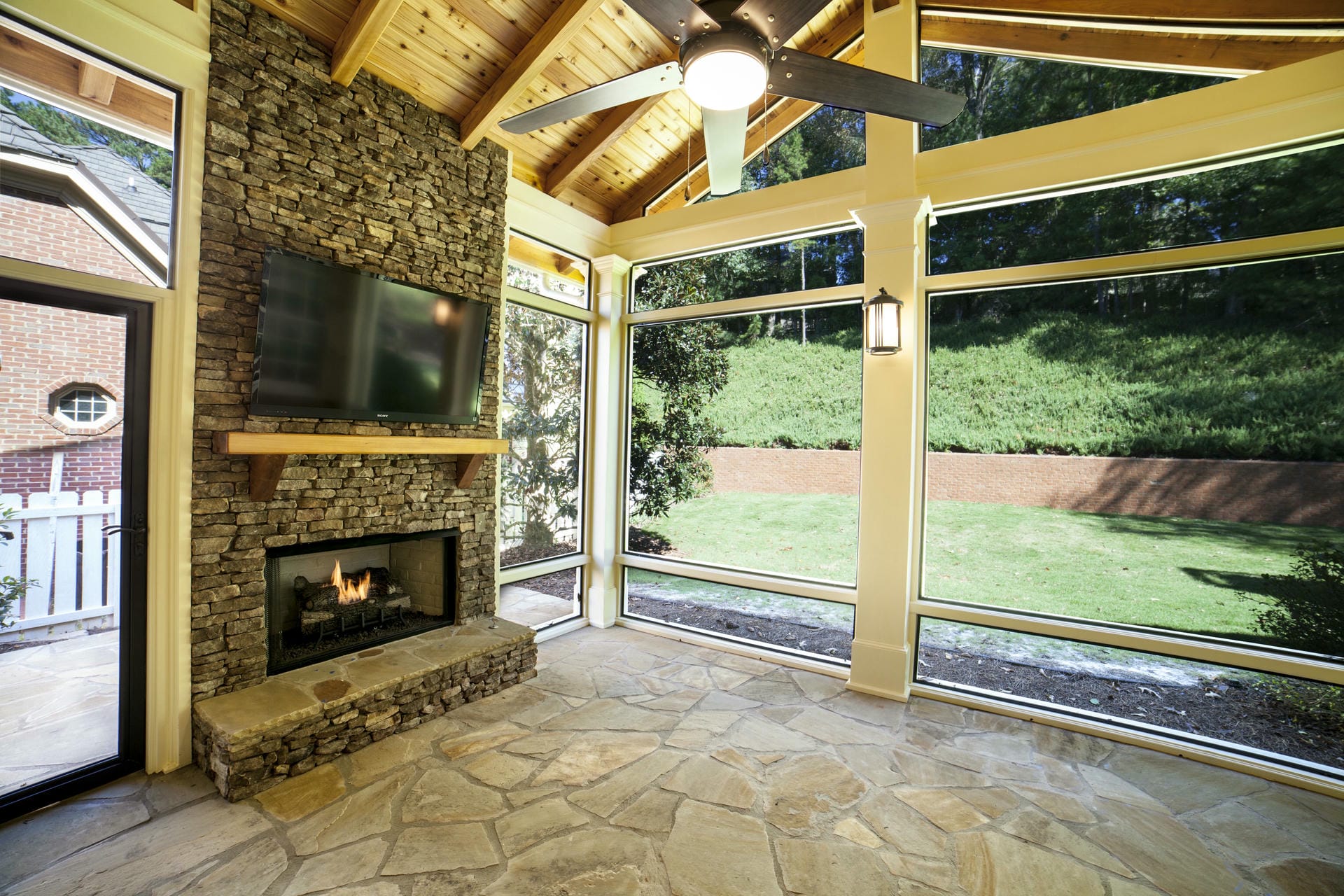 Finished porch interior with a wood-burning fireplace