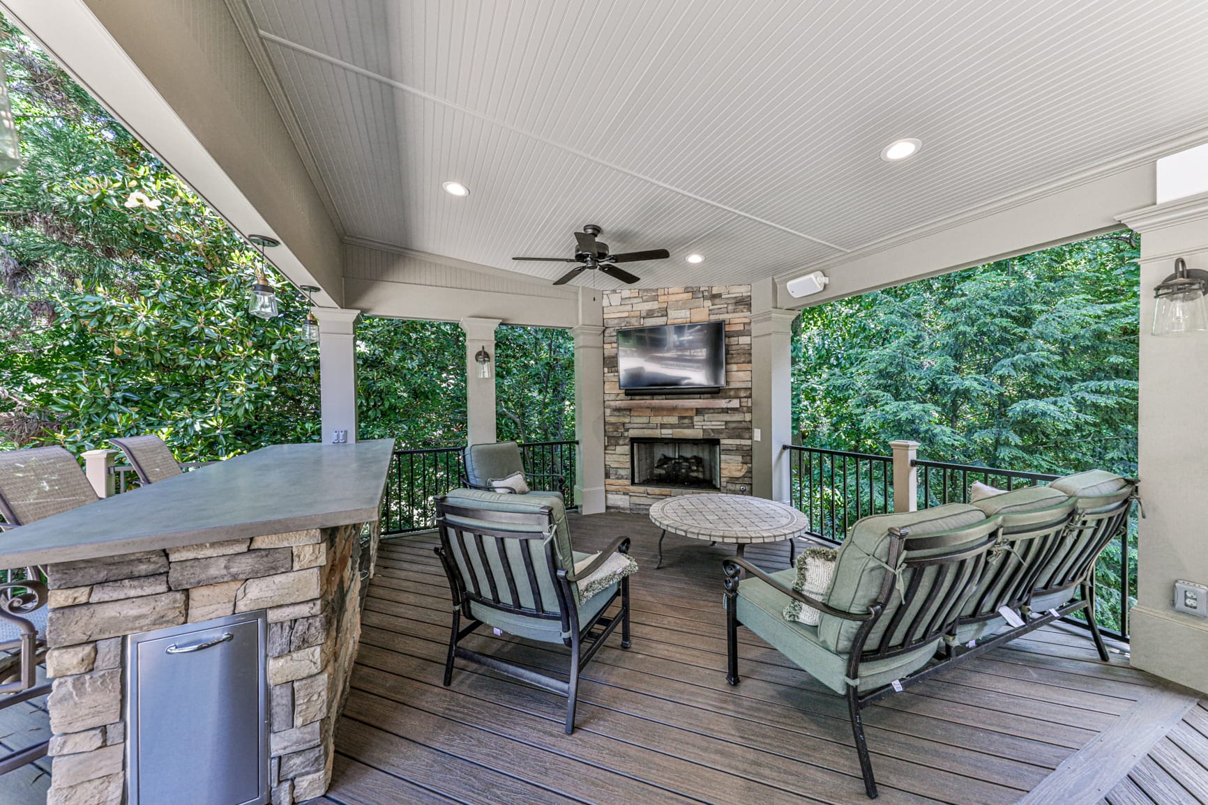 Porch fireplace anchoring a seating area on a covered porch