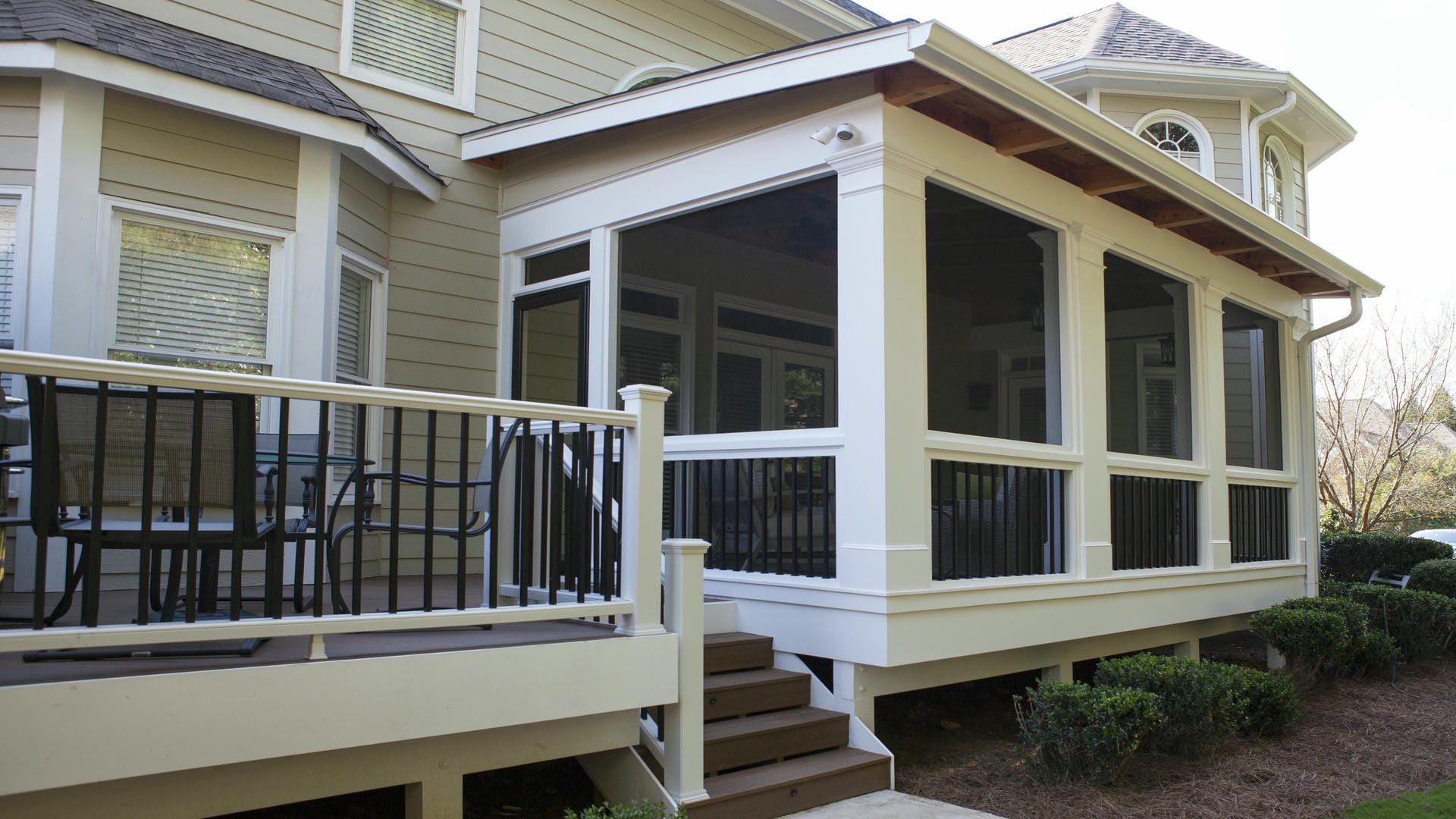 Screened porch with a low shed roof running off the main roofline of the house