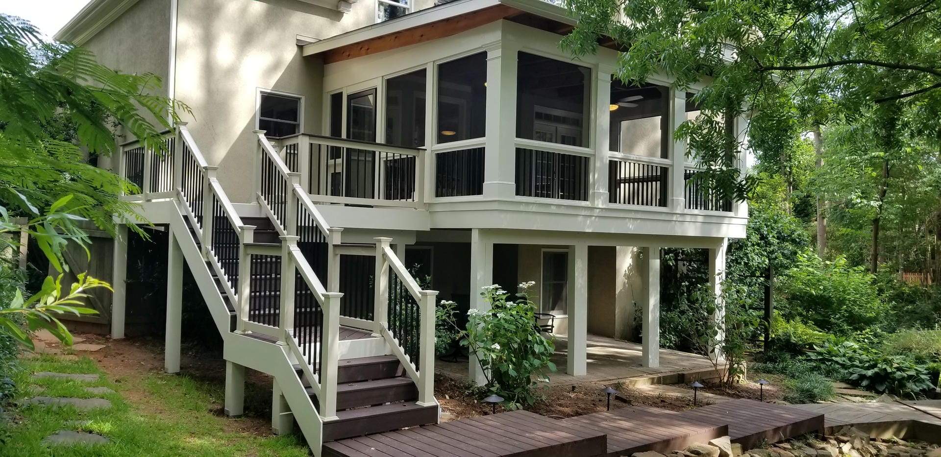 Elevated screened porch with a shed roof and stained beam above the screens
