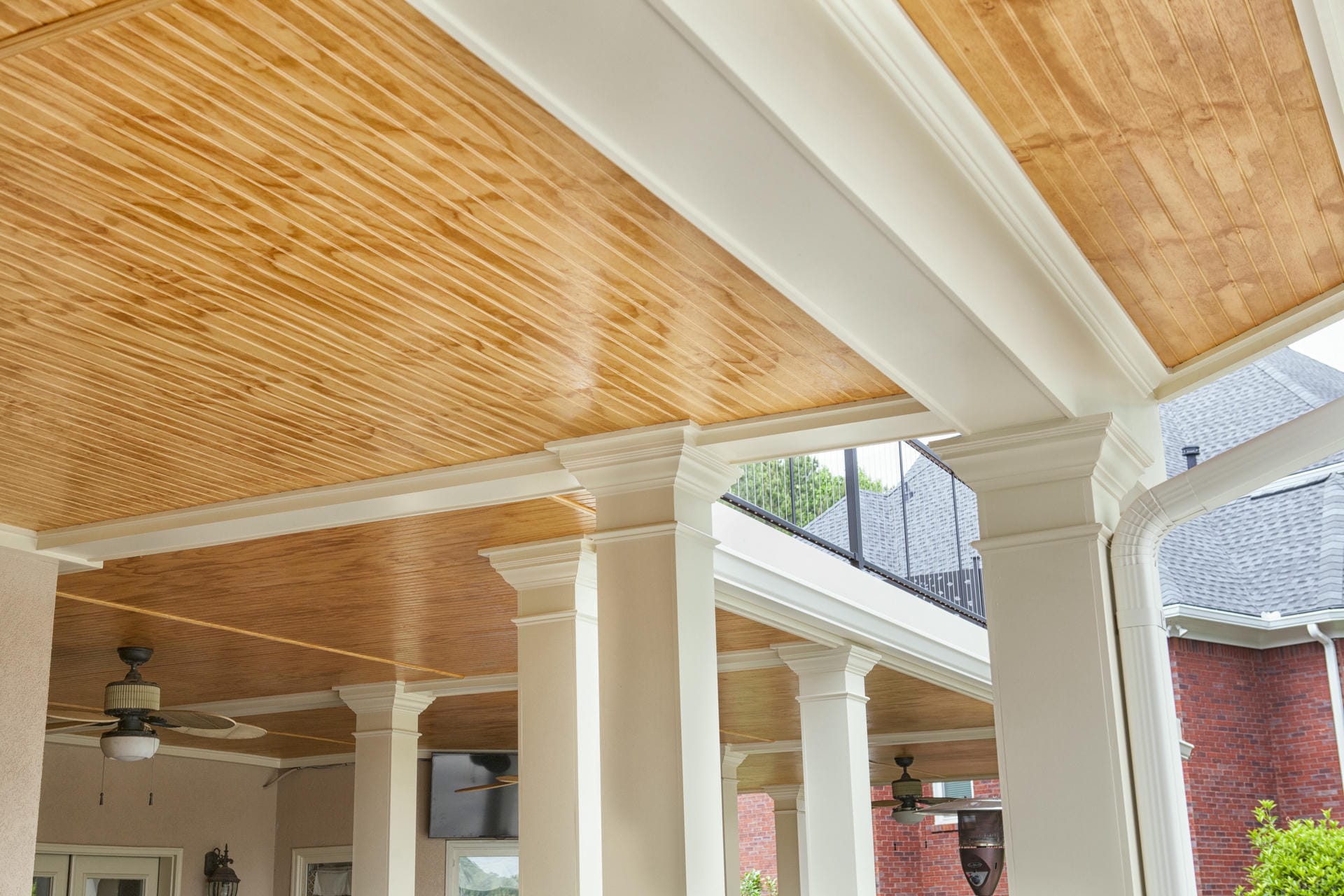 Column and beam detail where the wood ceiling meets the underside of the deck