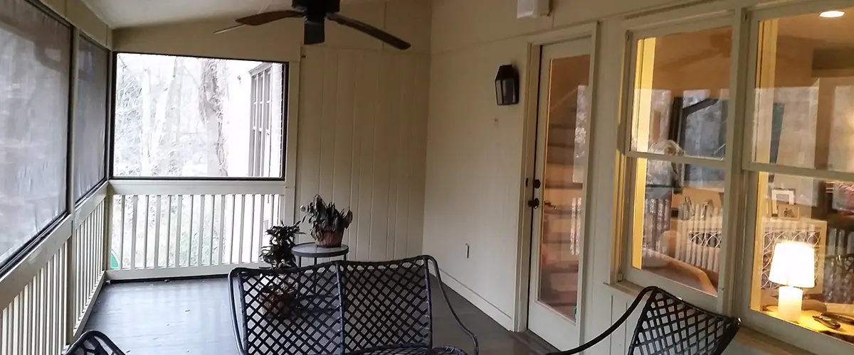 Screened porch interior with ceiling fans, outdoor seating and covered living area