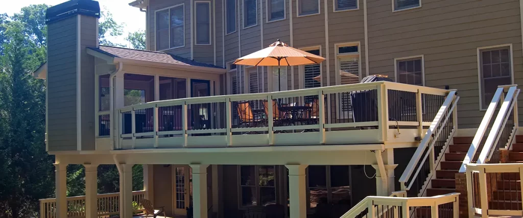 Elevated backyard deck with stairs, covered patio, outdoor dining area, and pool